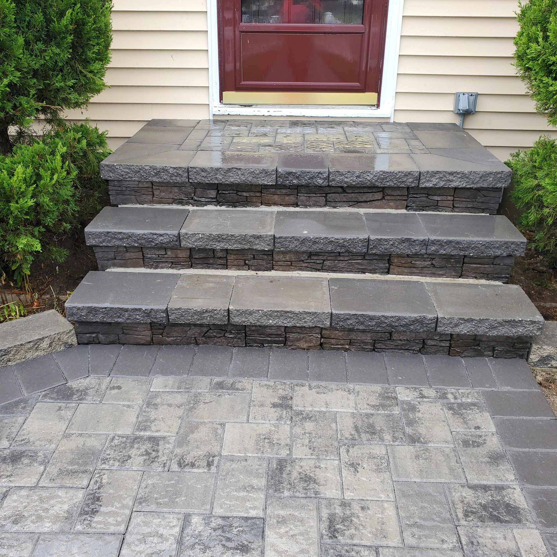 A set of steps leading up to a house with a red door