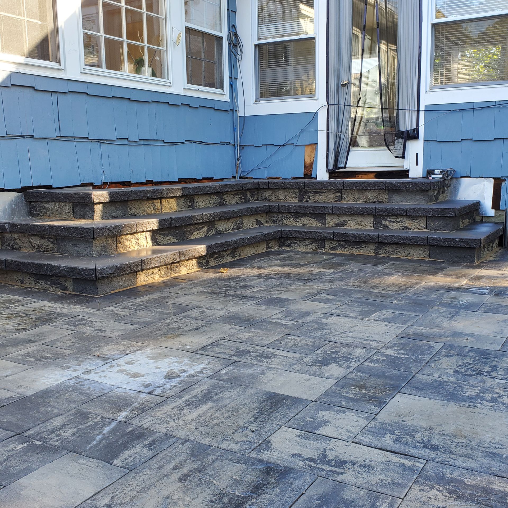 A blue house with stairs leading up to it