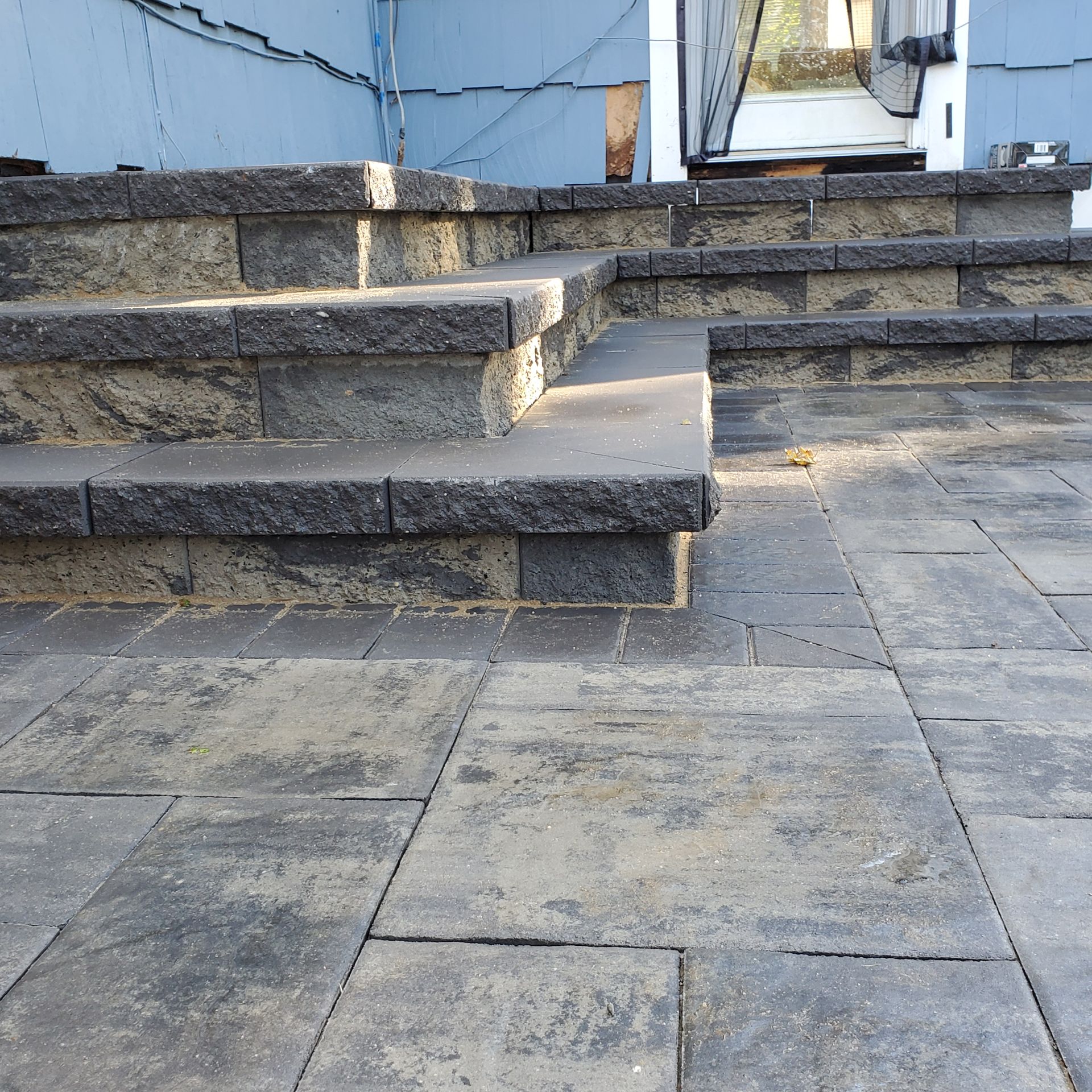 A set of stairs leading up to a blue building