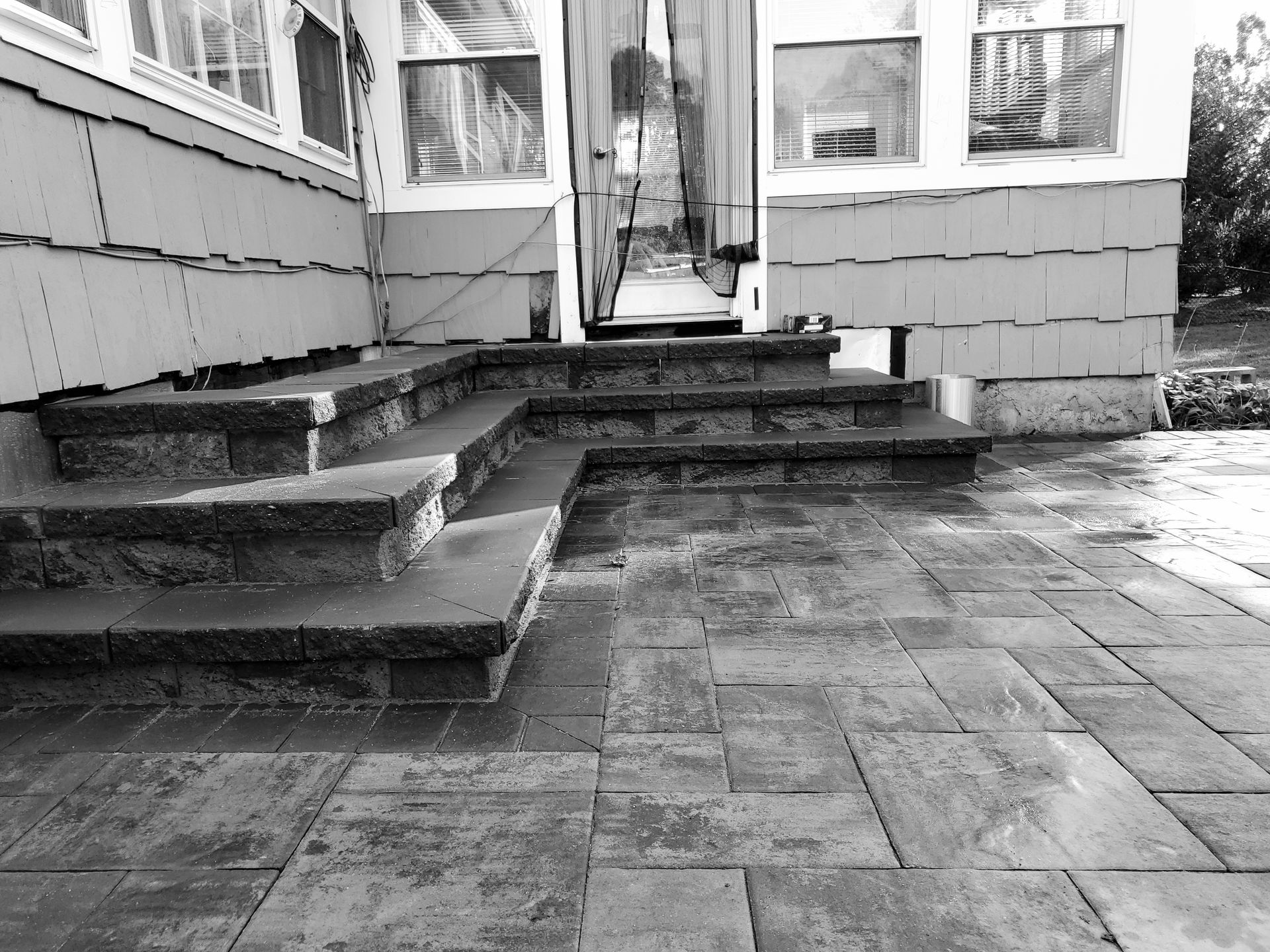 A black and white photo of stairs leading up to a house