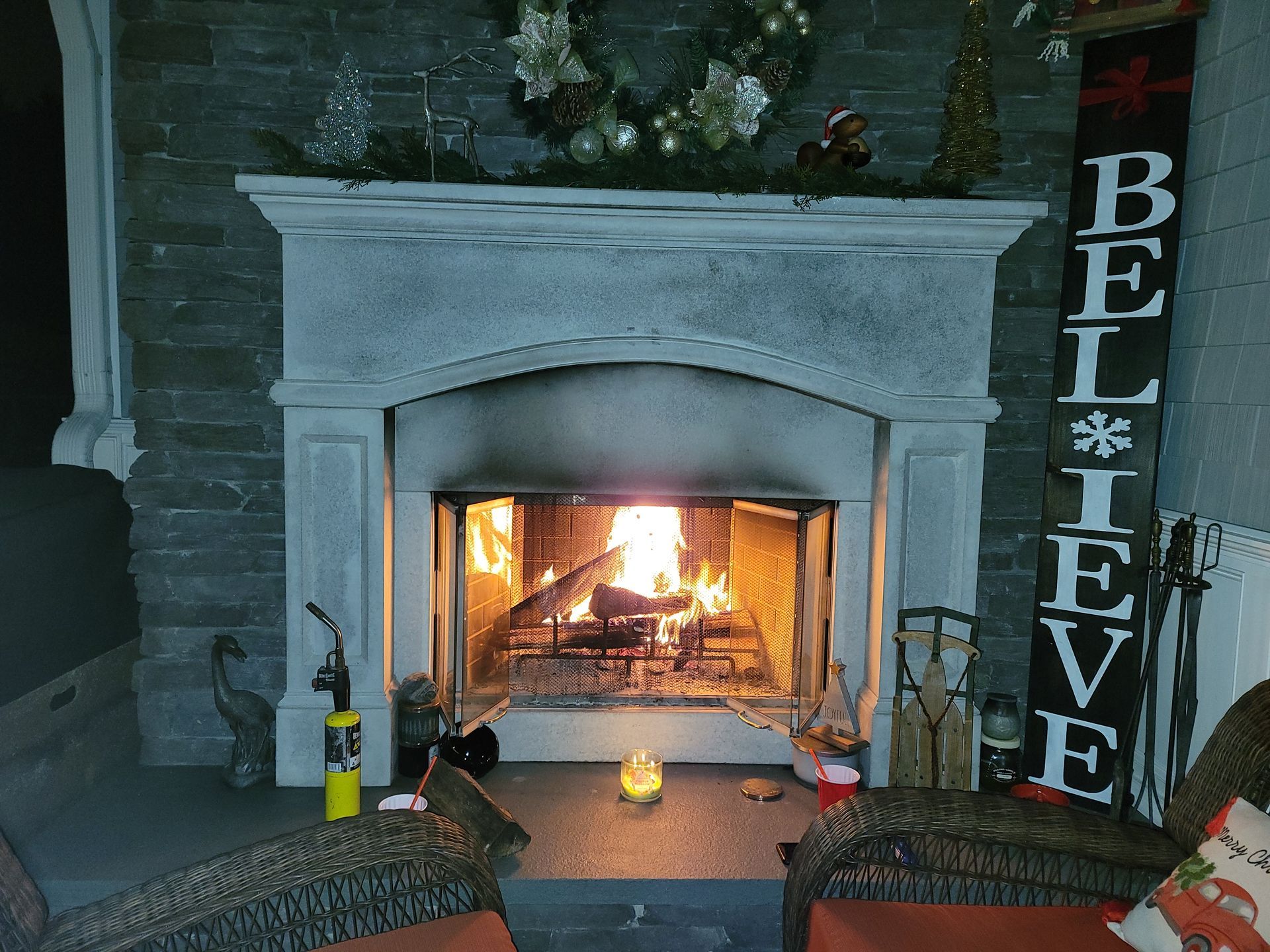 A fireplace with a sign that says believe on it