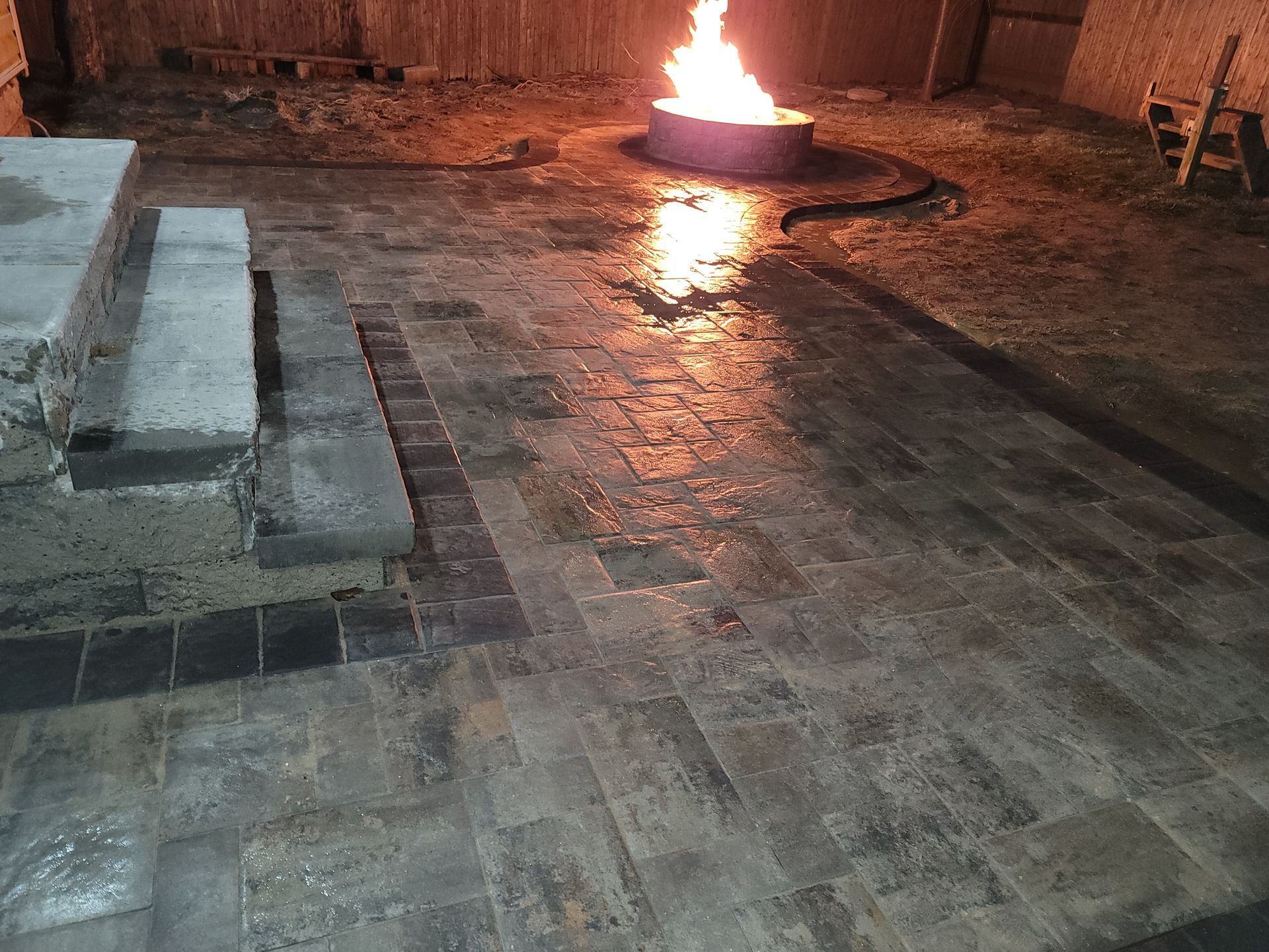 There is a fire pit in the middle of the patio.