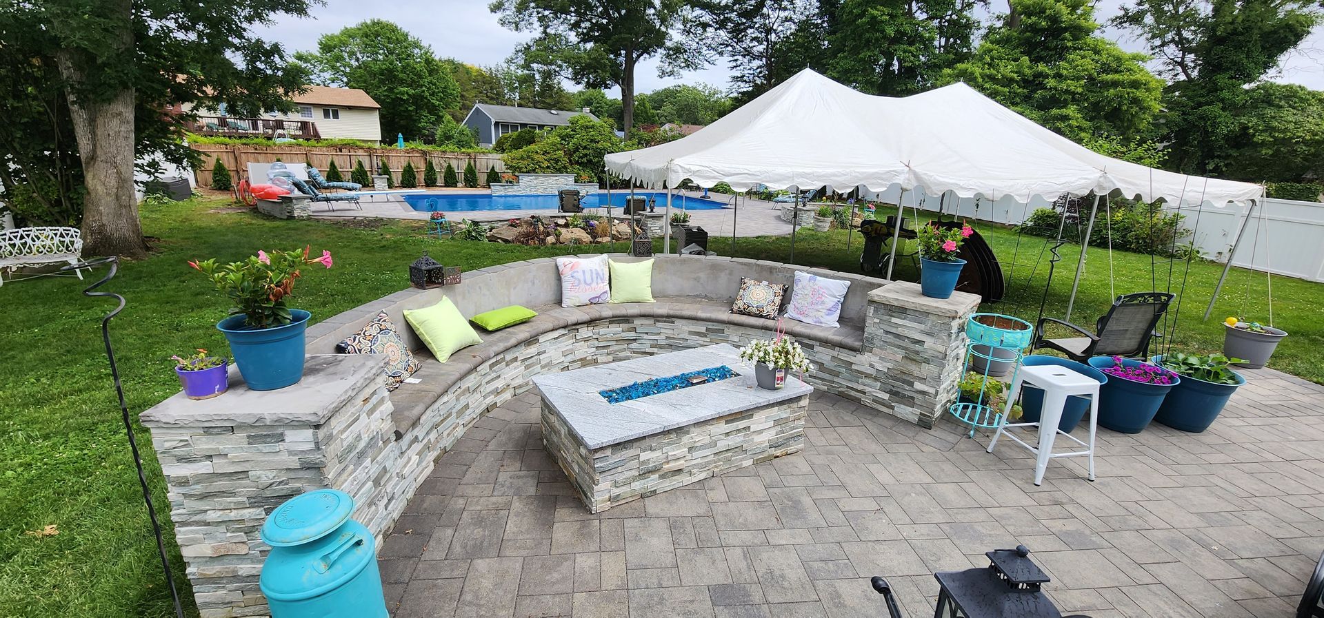 There is a fire pit in the middle of the backyard.