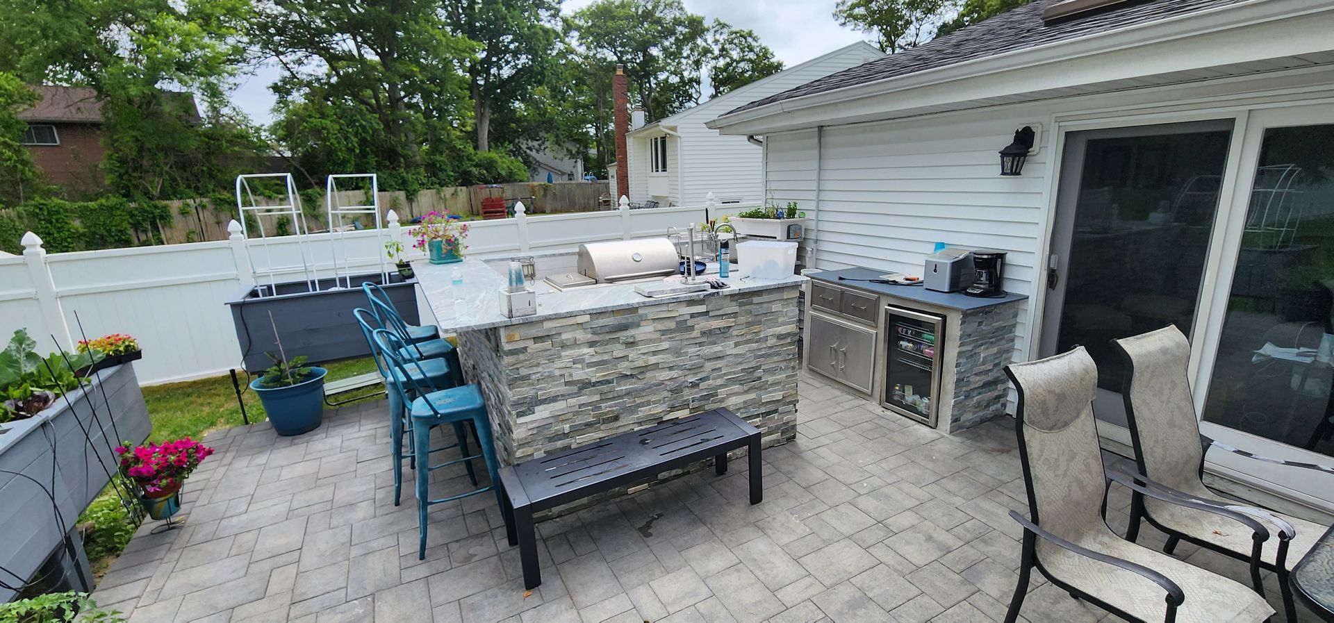 A patio with a table and chairs and a large island in the middle of it.