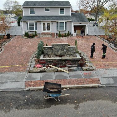 An aerial view of a house with a wheelbarrow in front of it.