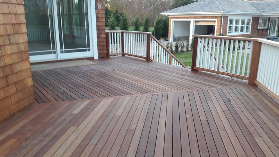 A wooden deck with stairs leading up to a house