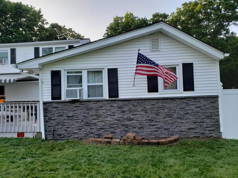 A white house with an american flag flying in front of it.
