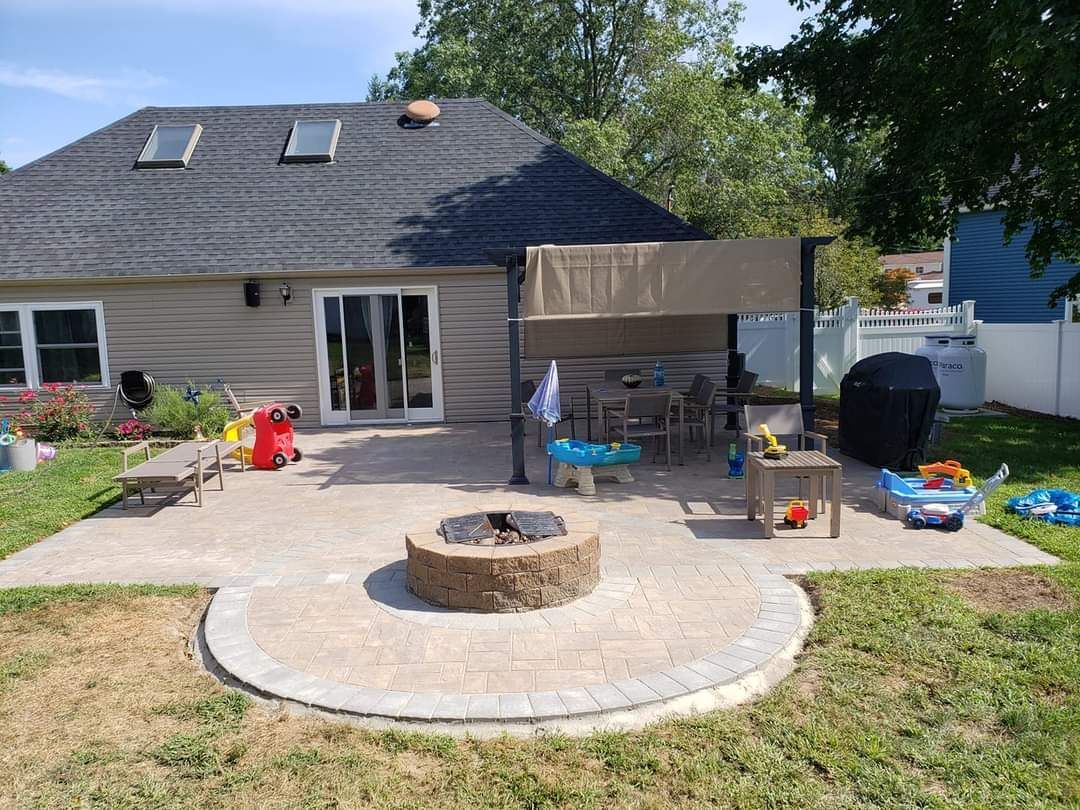There is a fire pit in the middle of the backyard.