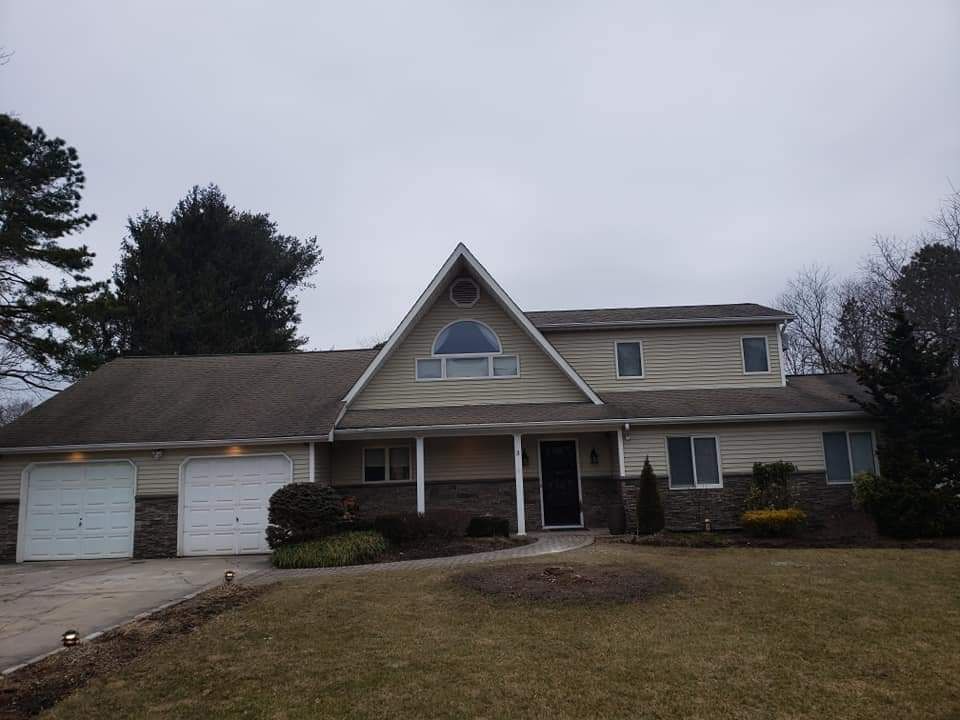 A large house with two garages and a large window