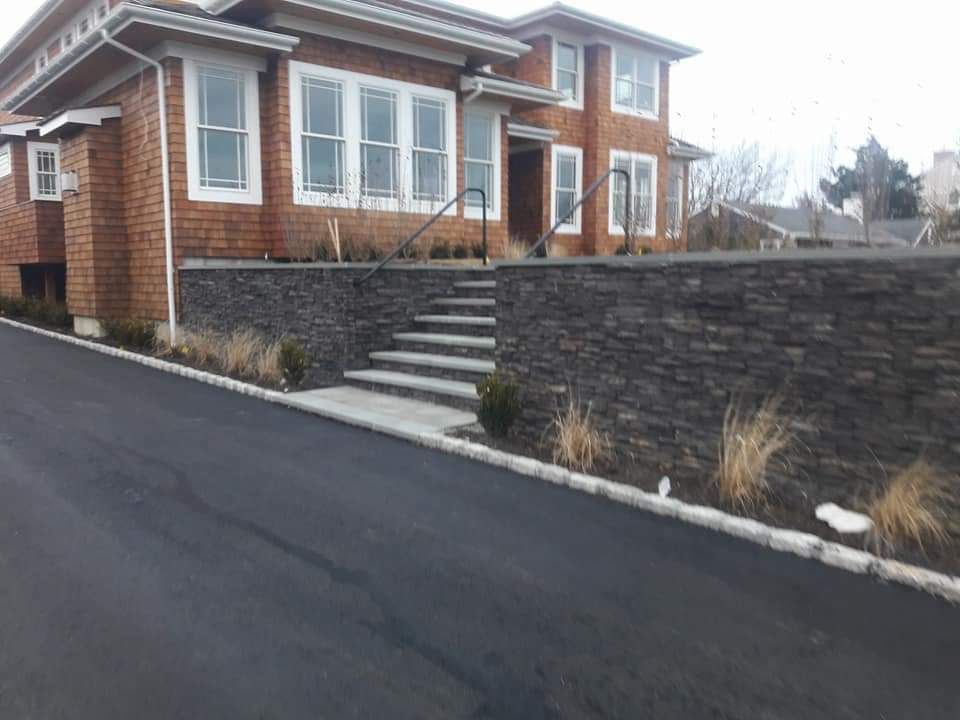 A large brick house with stairs leading up to it