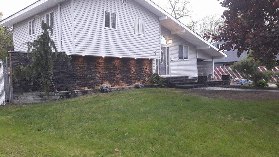 A white house with a large lawn in front of it