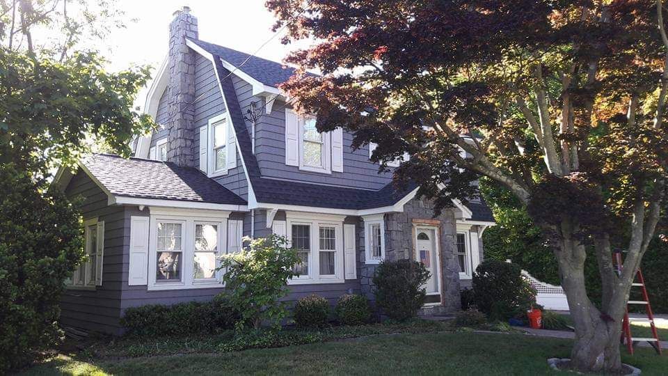A large house with a tree in front of it
