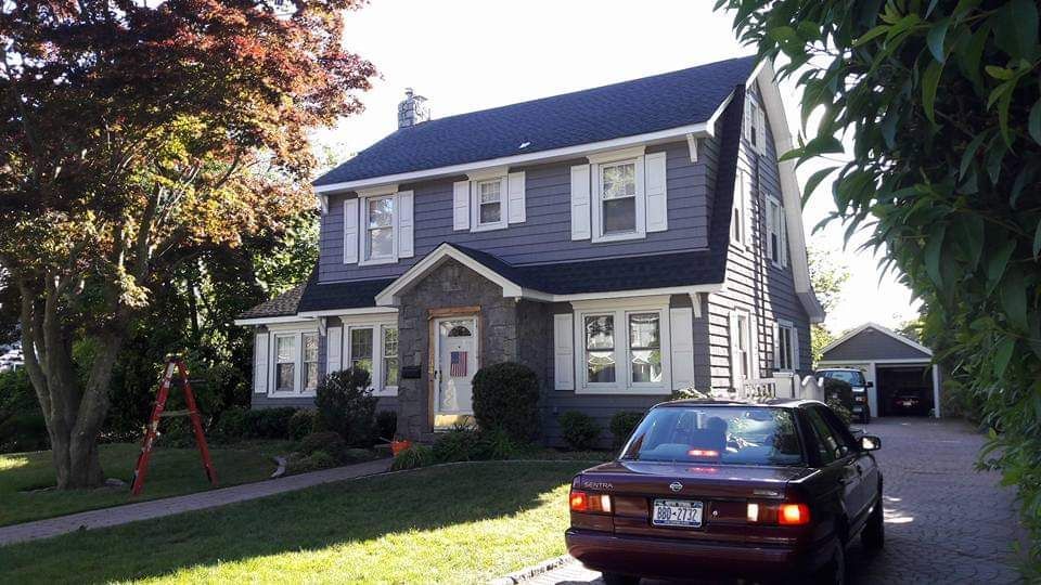 A house with a car parked in front of it