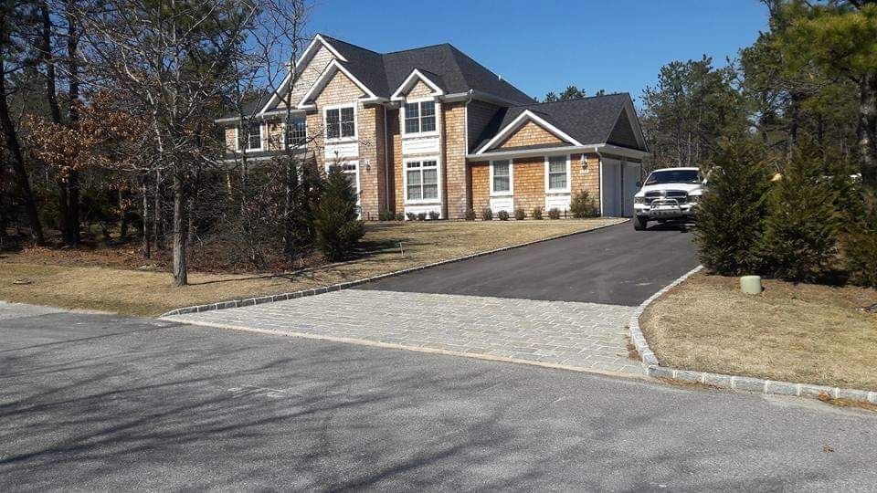 A large house with a car parked in front of it