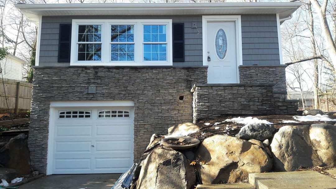 A small house with a garage and a window