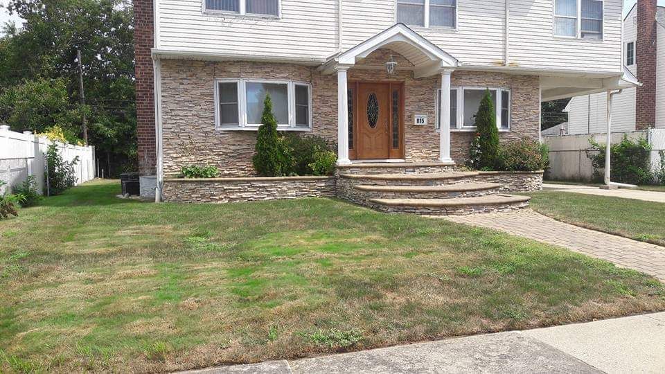 A large house with a lush green lawn in front of it.