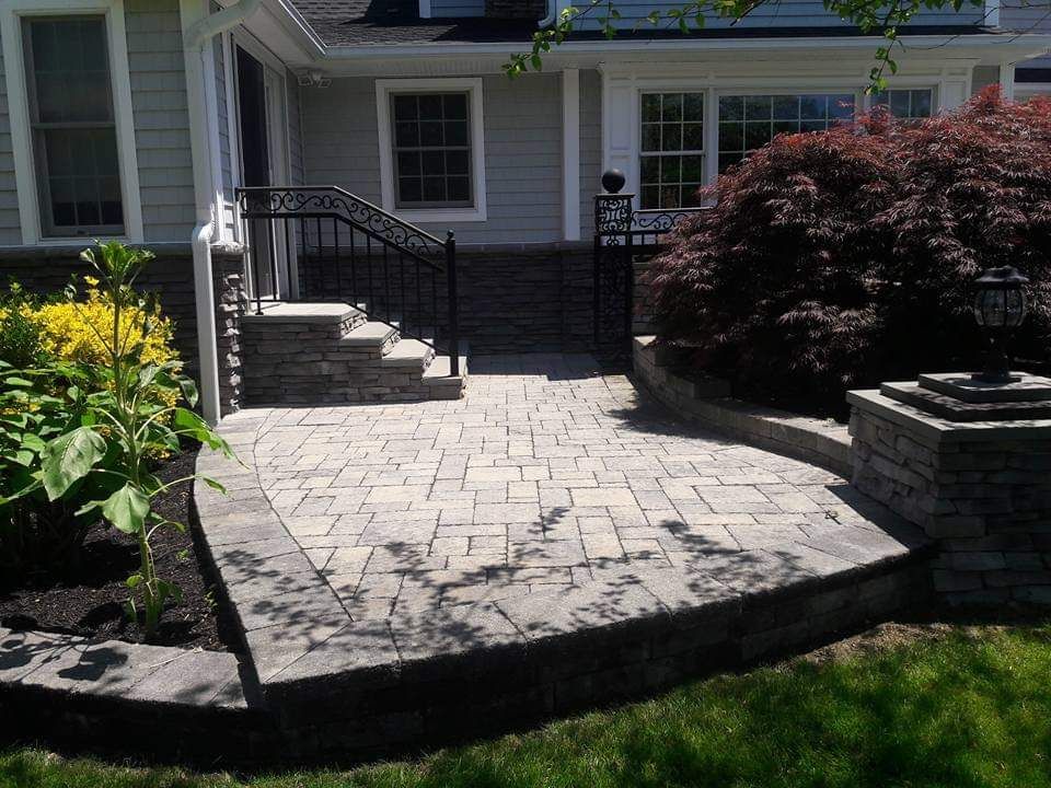 A house with a patio and stairs in front of it