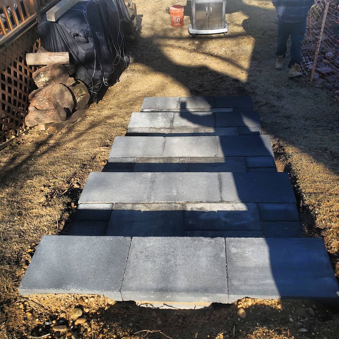 A set of stairs made of bricks are being built in the dirt.
