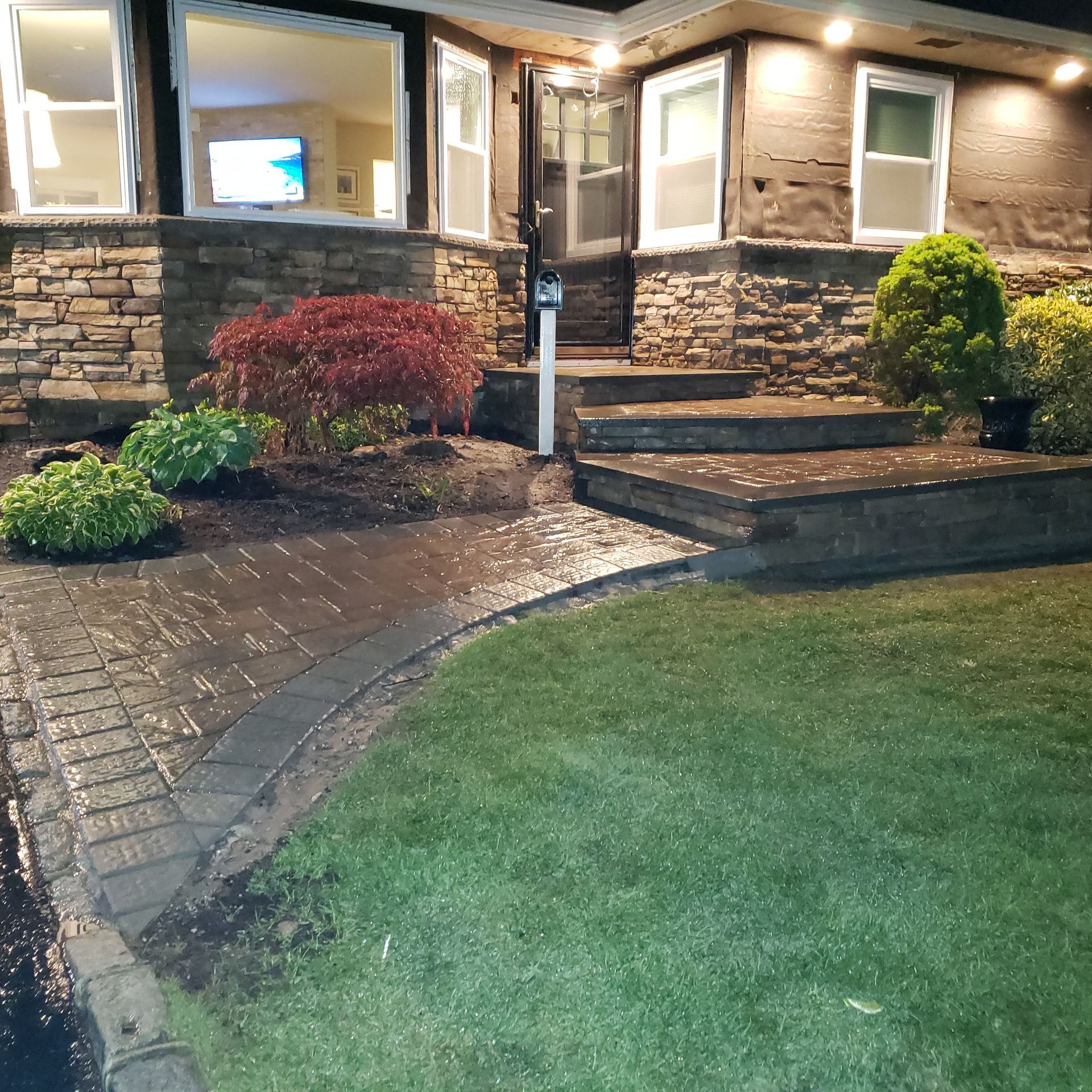 A house with a brick walkway leading to the front door