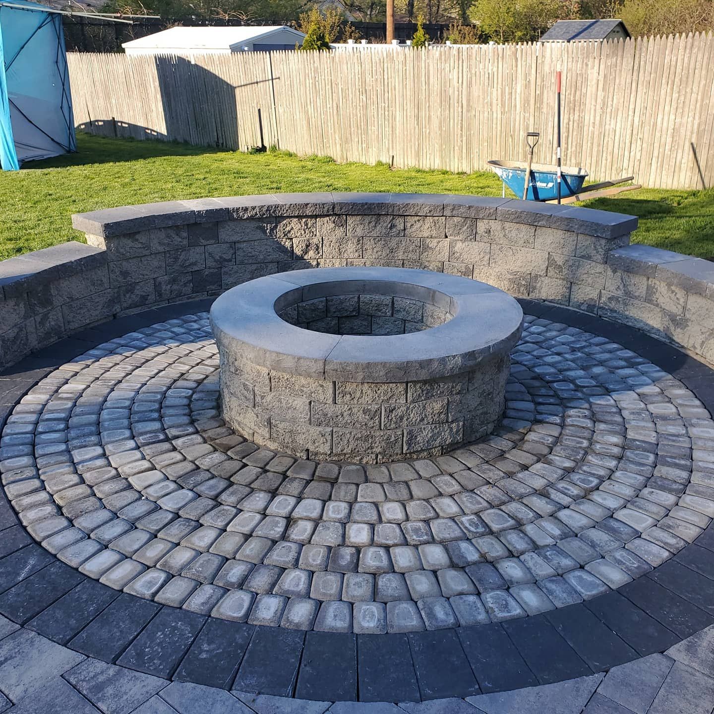 A fire pit is surrounded by bricks in a circular pattern.