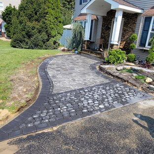 A brick walkway is being built in front of a house.