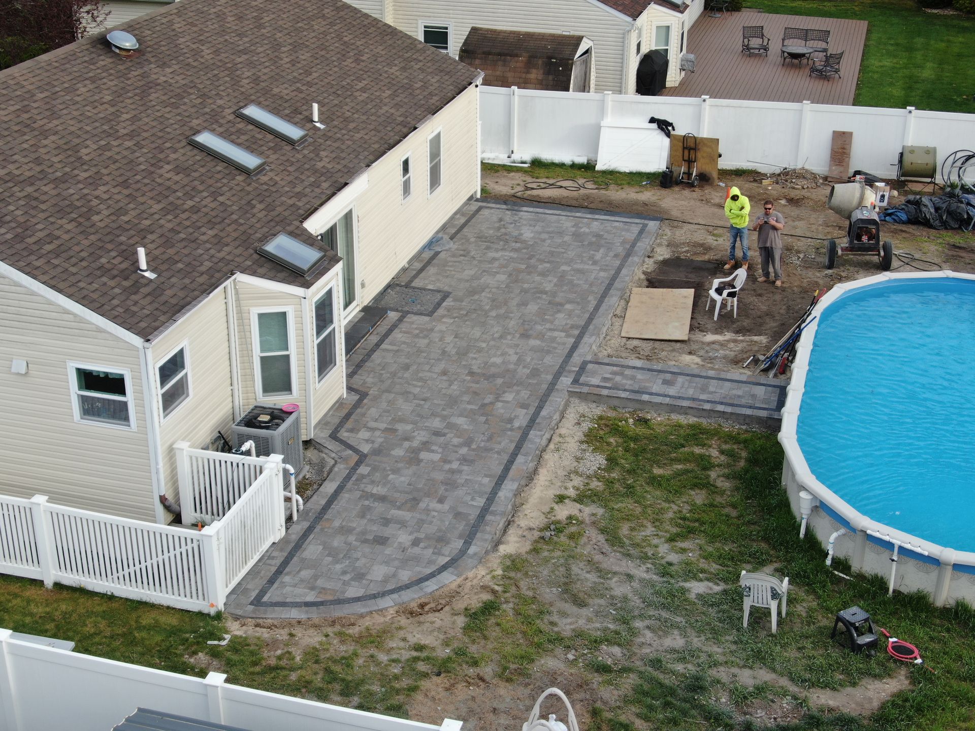 An aerial view of a house with a pool in the backyard.