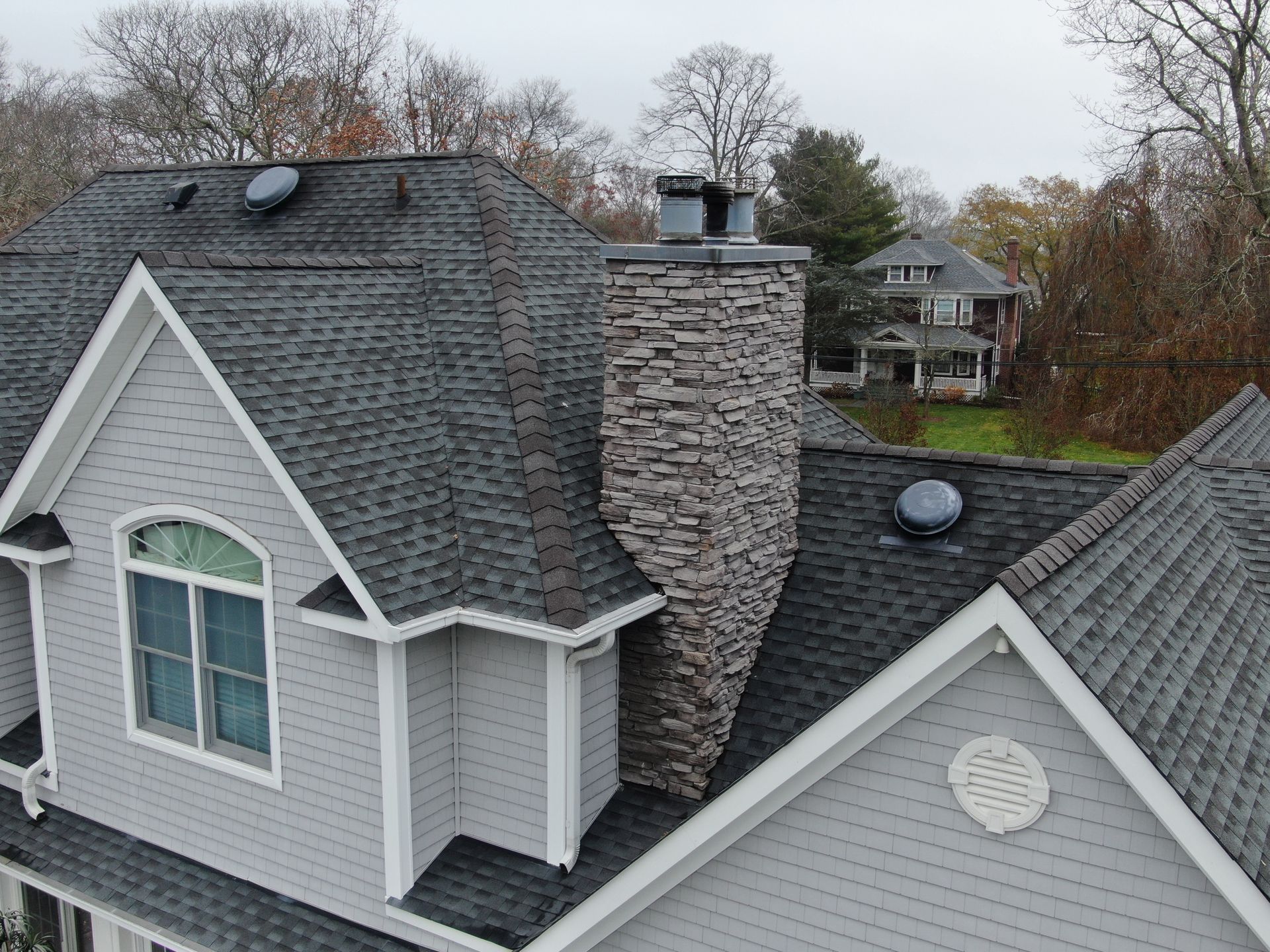 An aerial view of a house with a chimney on the roof.