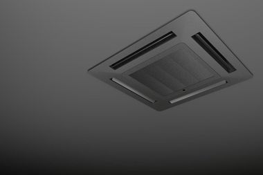 HVAC technician in red uniform installing outdoor air conditioning unit on a wall, using a ladder.