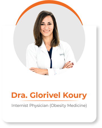 A woman in a white lab coat is standing with her arms crossed.