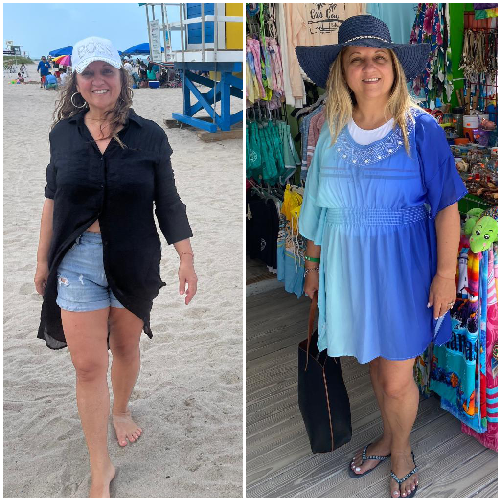 A woman is standing on a beach wearing a black shirt and a blue dress.