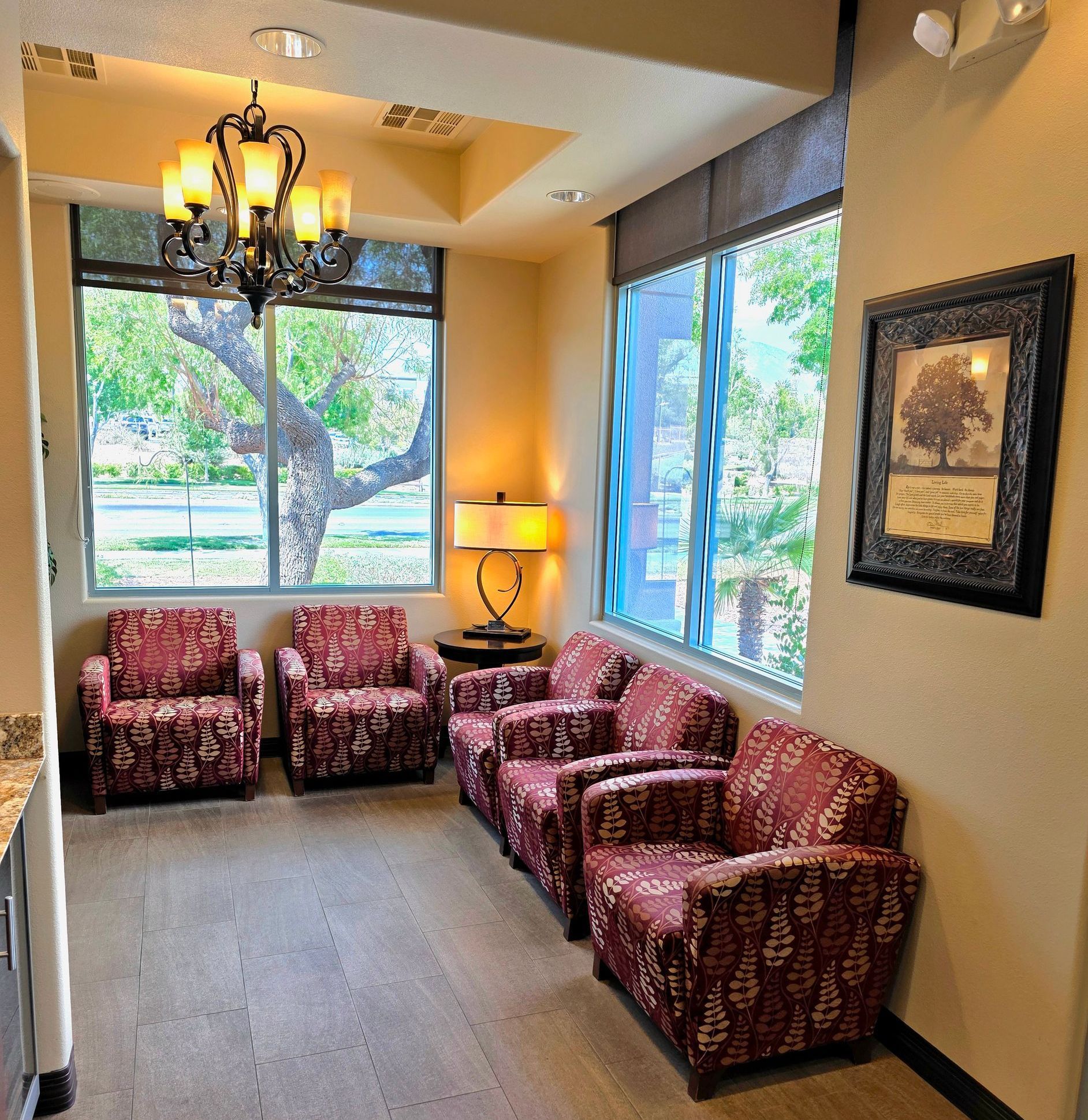 Reception area with a curved granite countertop, a dark wooden base, and a sign that reads