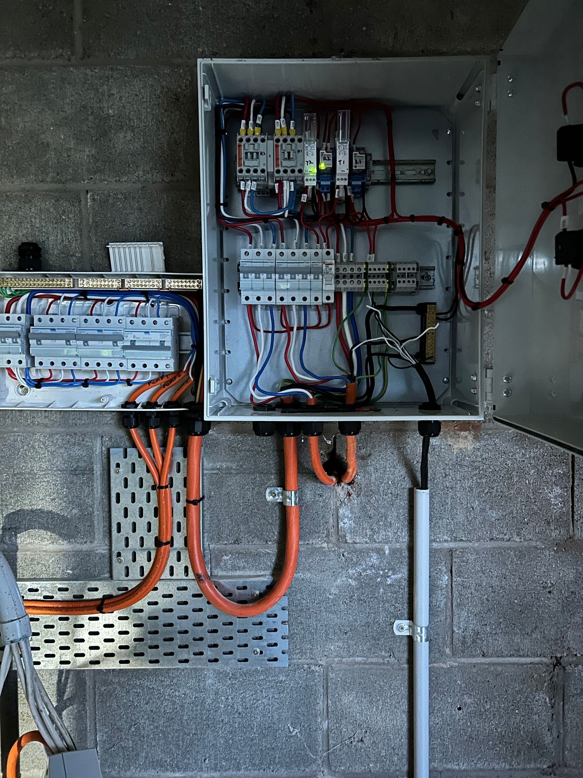 Electrical panel with orange cables, wired connections — CDT Electrical in Lennox Head, NSW
