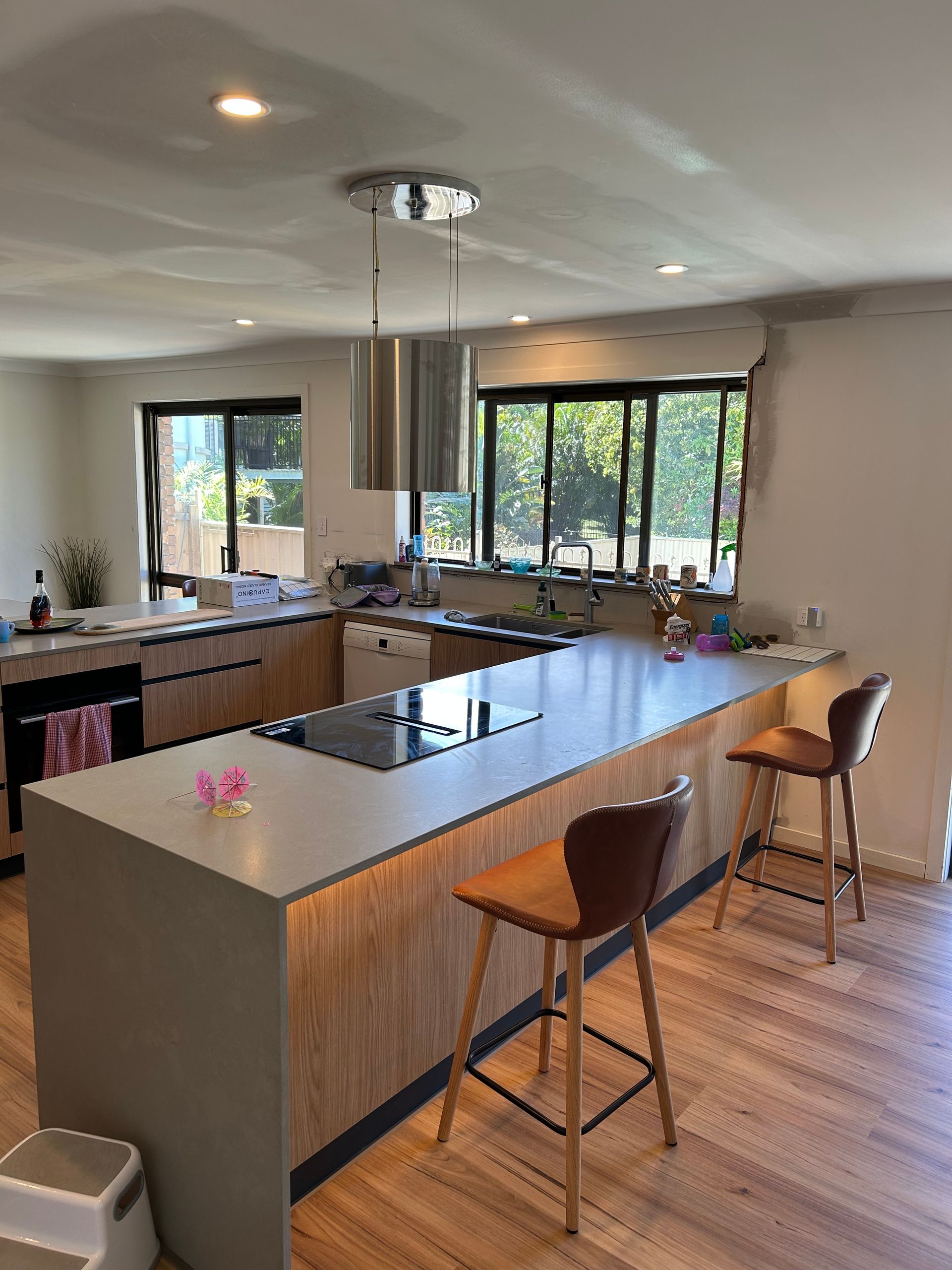 Modern Kitchen With Island, Wooden Cabinets, Stainless Steel Range Hood — CDT Electrical in Lennox Head, NSW