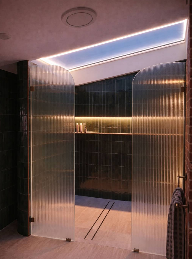 Shower With Reeded Glass Doors, Open to a Space With Dark Green Tile — CDT Electrical in Kingscliff, NSW