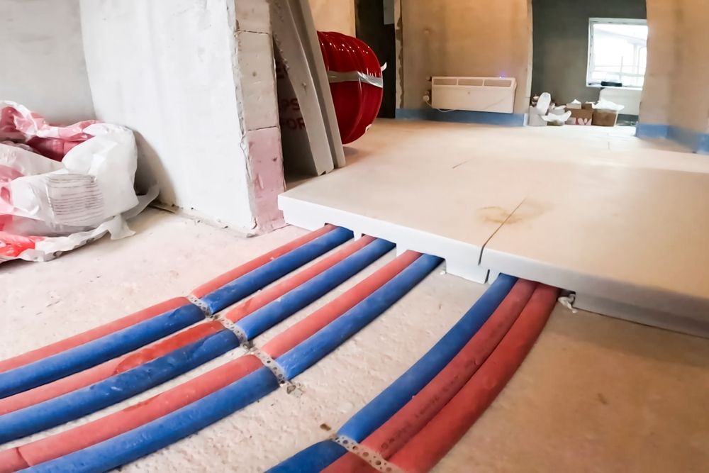 Under-construction Floor Showing Blue and Red Pipes — CDT Electrical in Byron Bay, NSW