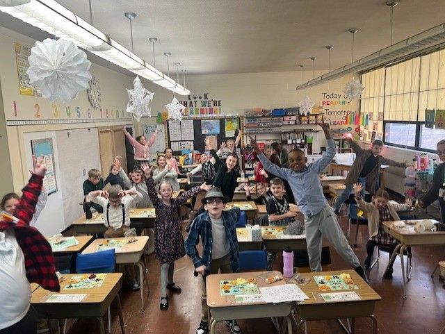 A group of children are posing for a picture in a classroom