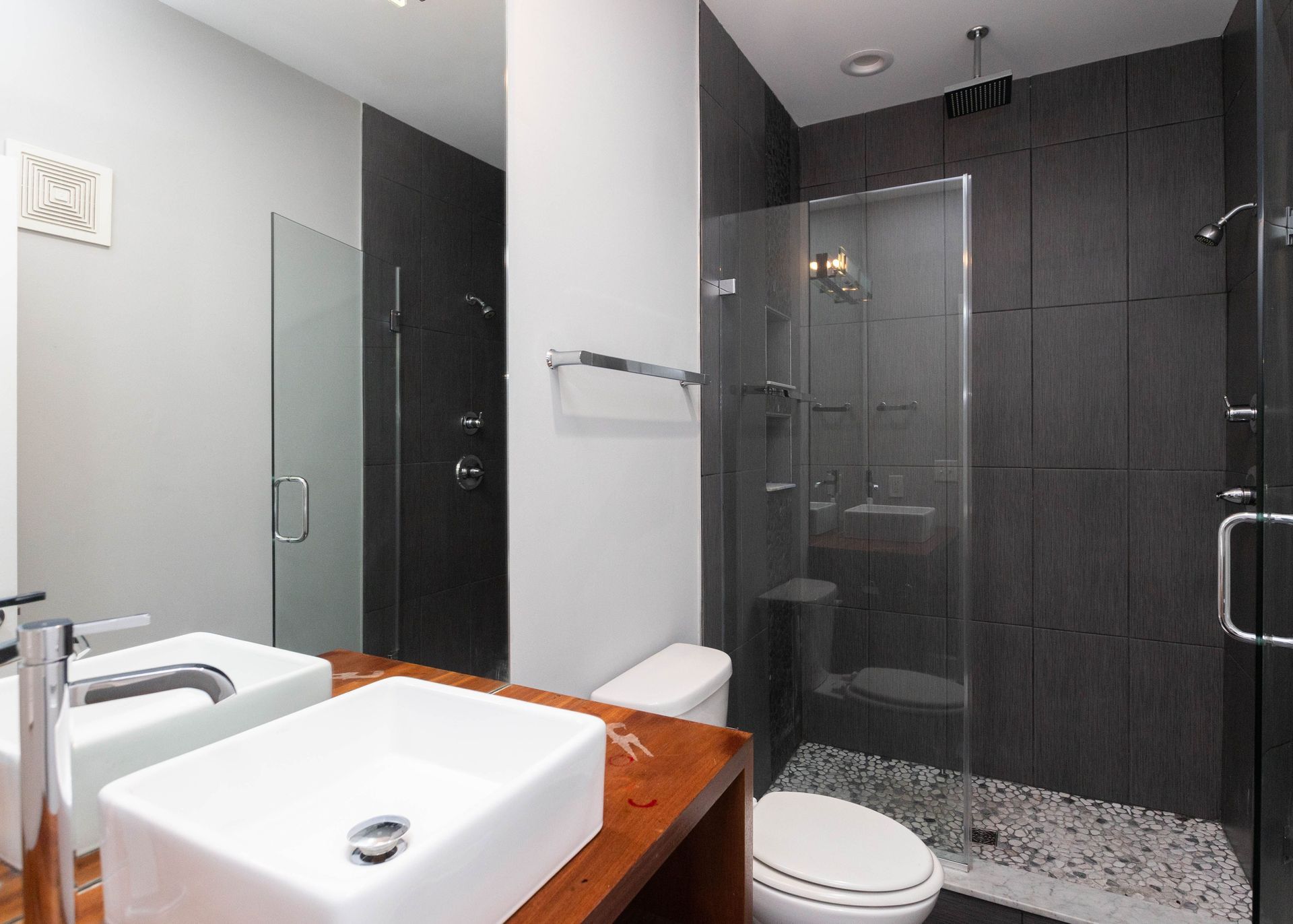 a bathroom with a toilet , sink and shower .