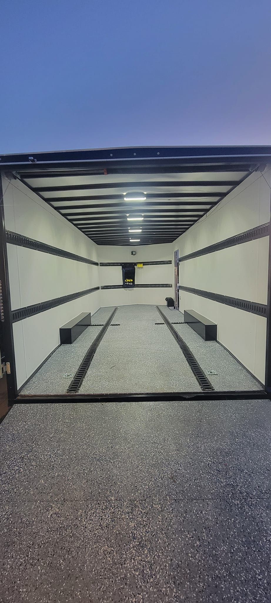 The inside of a trailer with a blue sky in the background.
