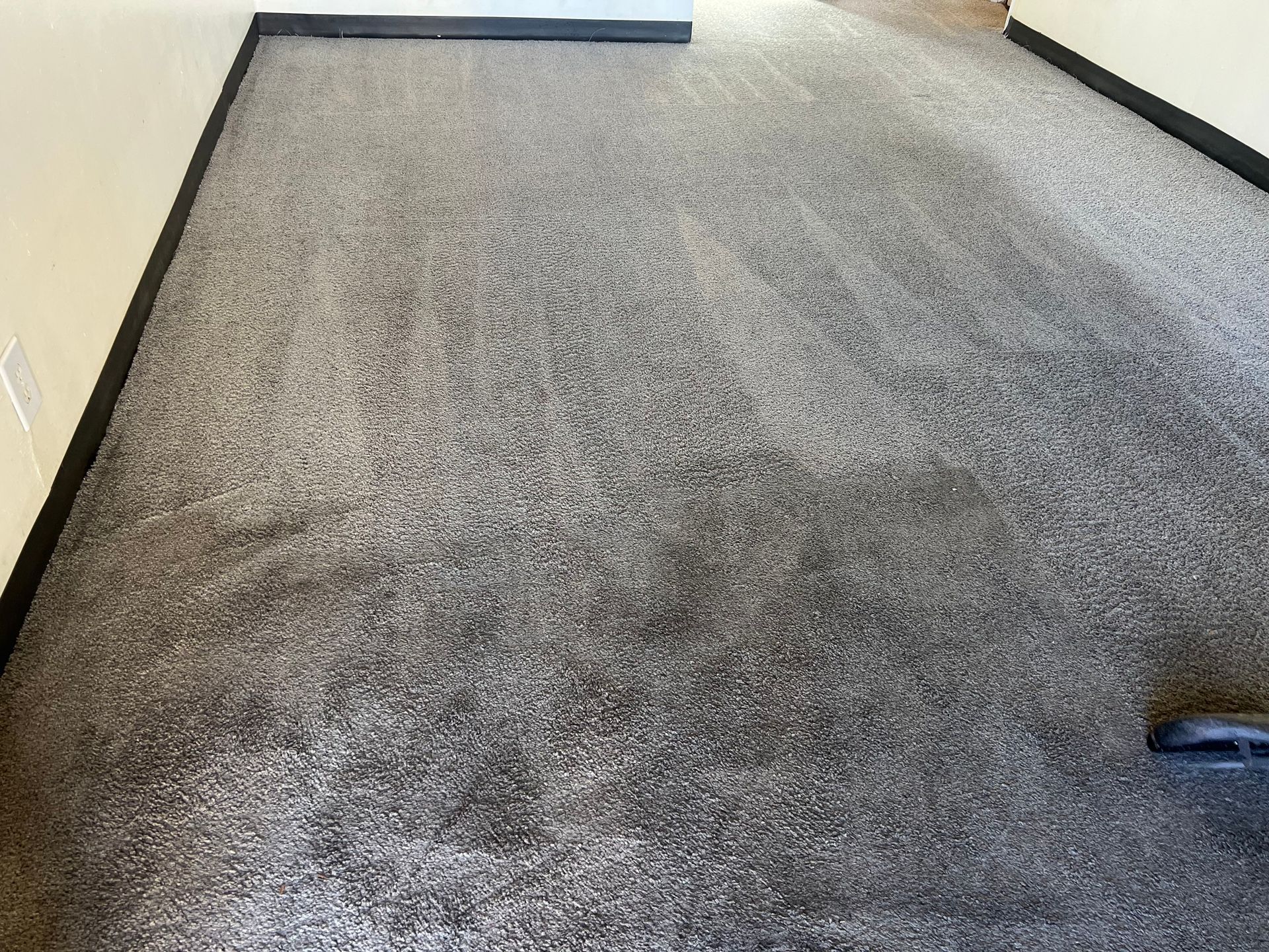 Grey carpet with black trim, viewed from above.
