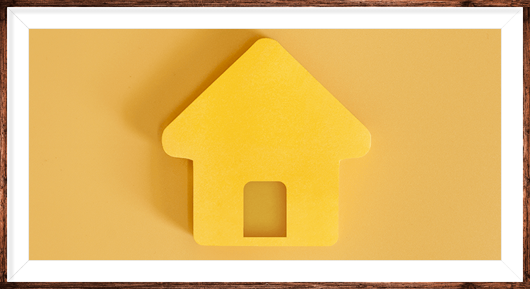 A picture of a yellow house with a white frame around it