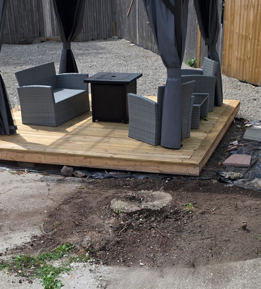 Stump Grinding near the raised patio with a table and chairs in Pleasant Ridge, MI