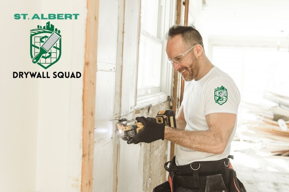 A drywall repair company in a white t-shirt is using a power tool to work on a commercial drywall installation. The commercial construction project is located near 45 St, and 47 Ave, Gibbons, AB.