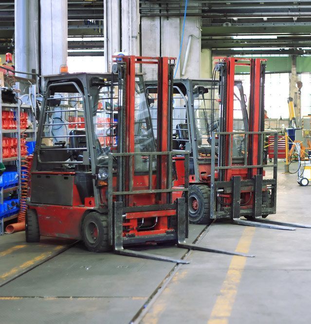 Forklifts in a warehouse— Twin Peaks Finance In Helensvale, QLD
