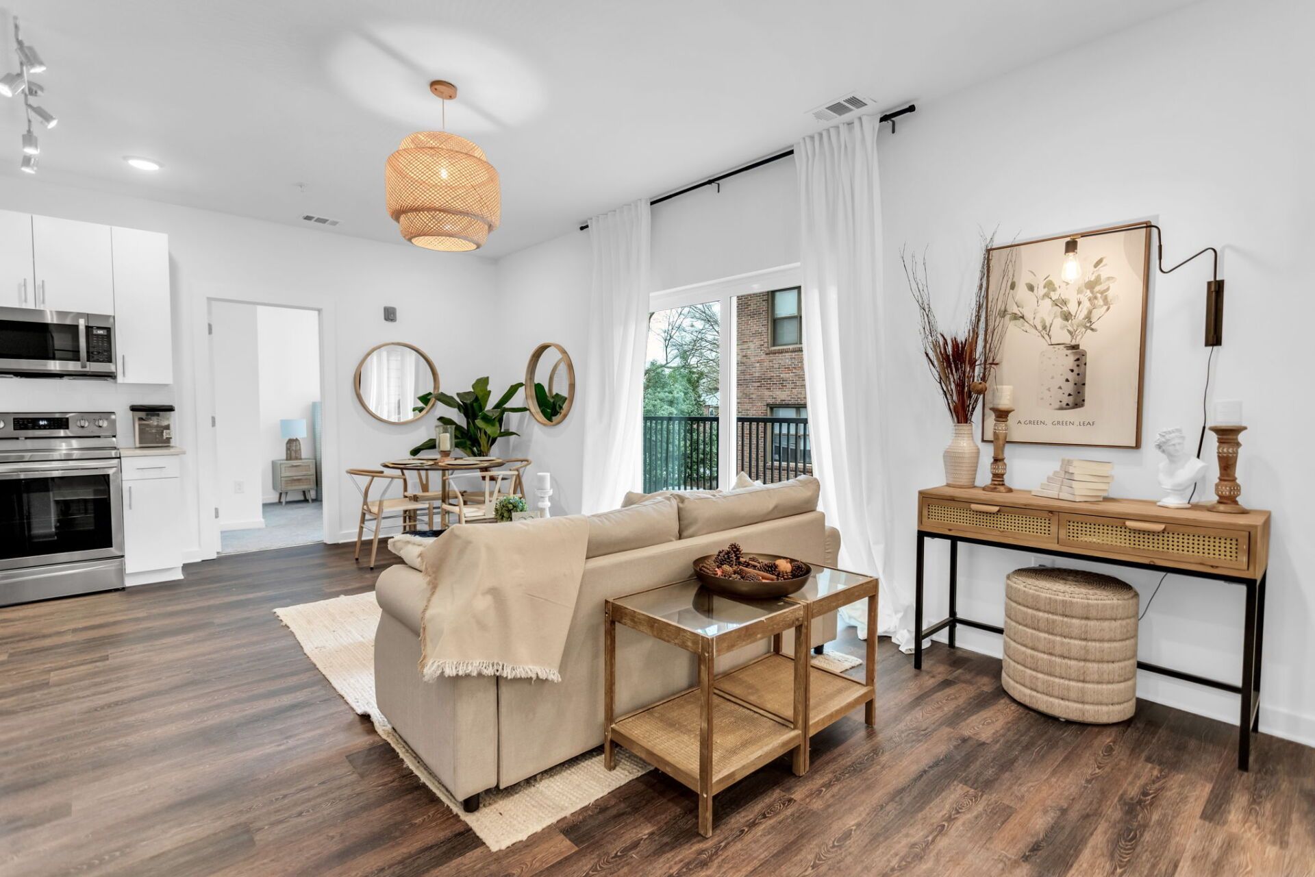 A living room with a couch , table , and sliding glass doors.