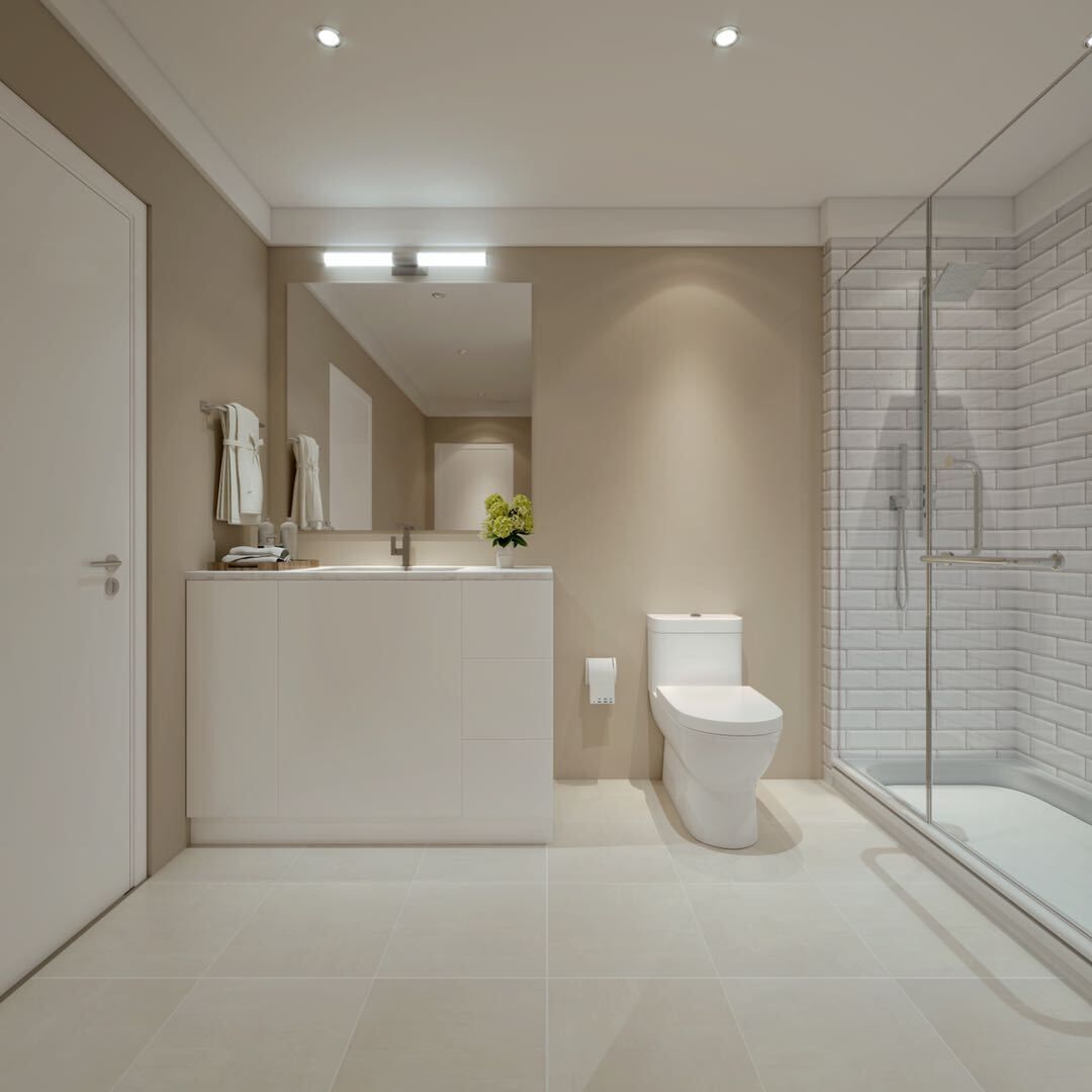 A bathroom with a toilet a sink and a walk in shower