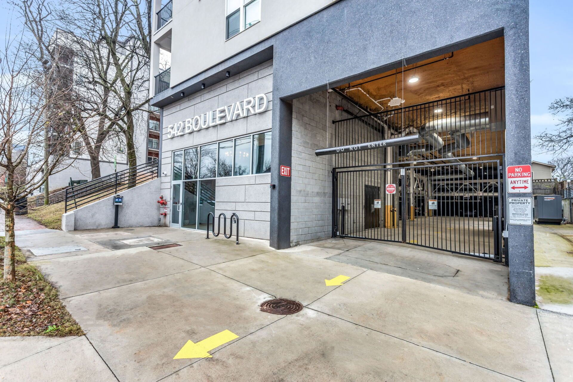 A large building with a parking garage in front of it.