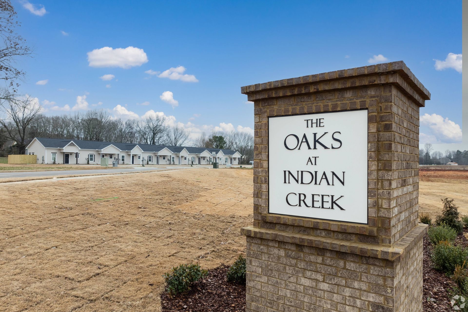 A brick sign for the oaks at indian creek