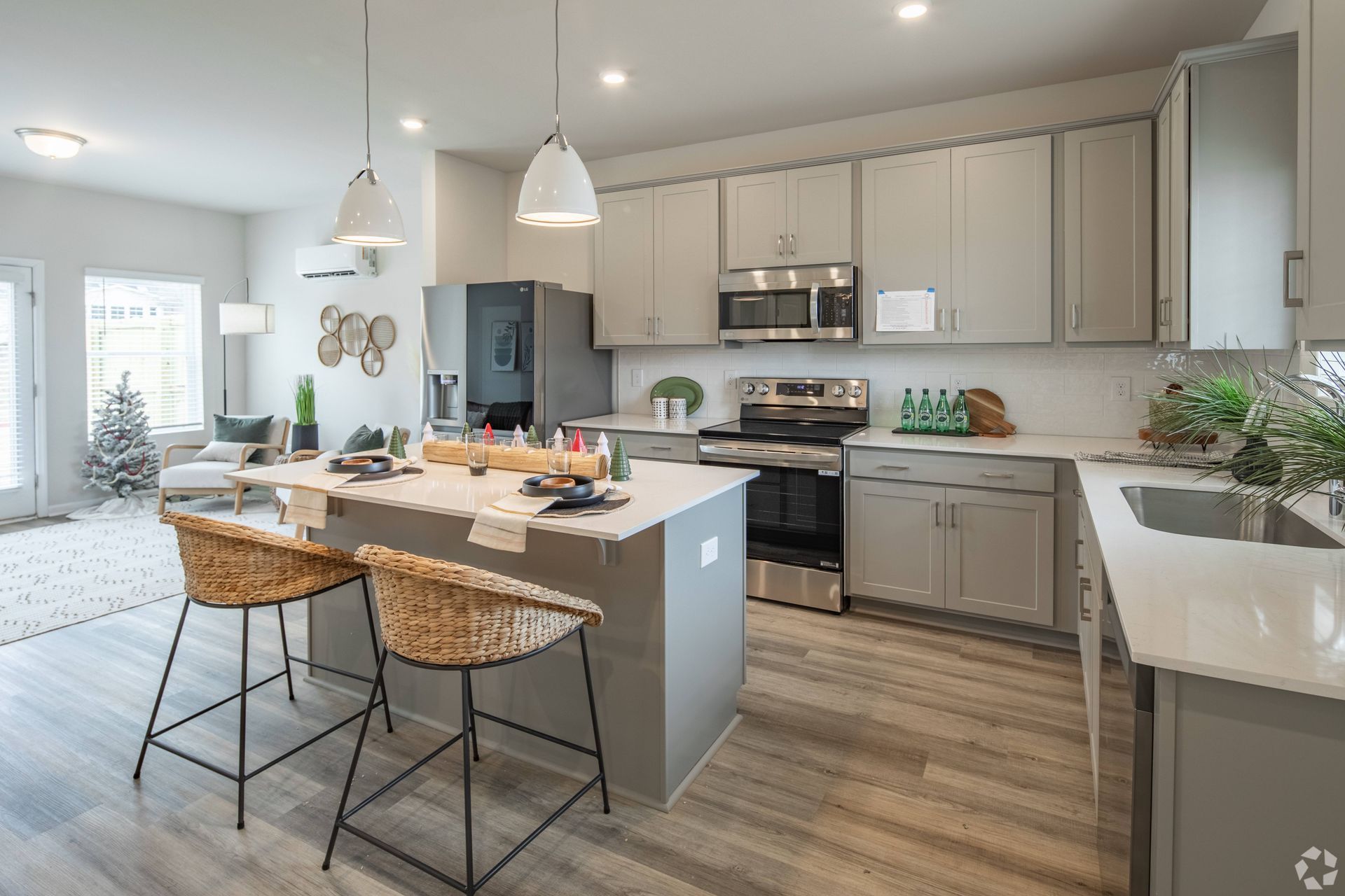 A kitchen with stainless steel appliances , white cabinets , and a large island.