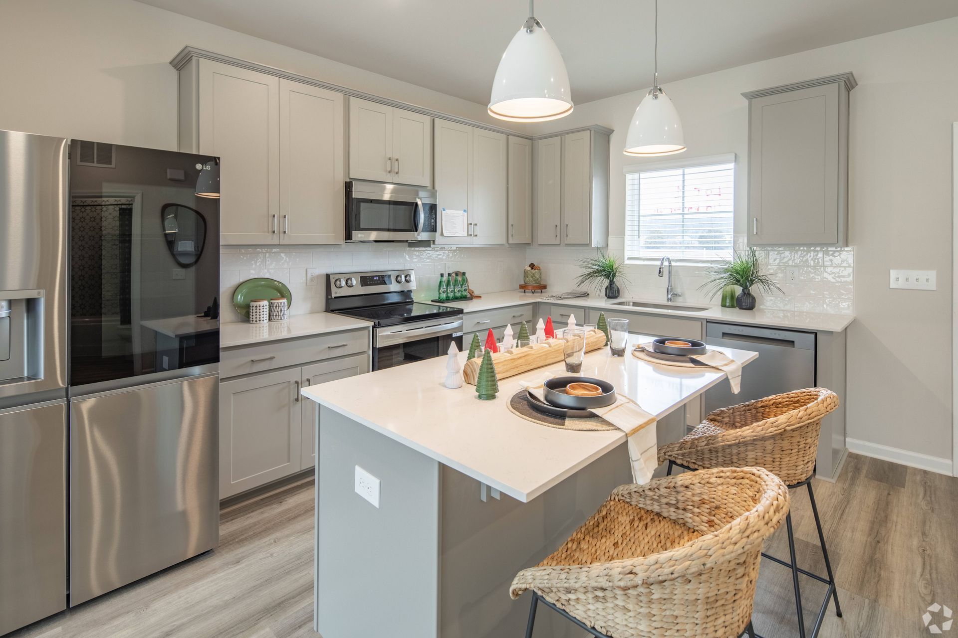 A kitchen with stainless steel appliances and a large island.