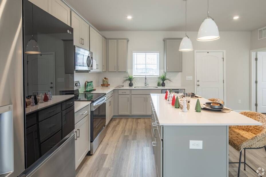 A kitchen with stainless steel appliances and a large island.